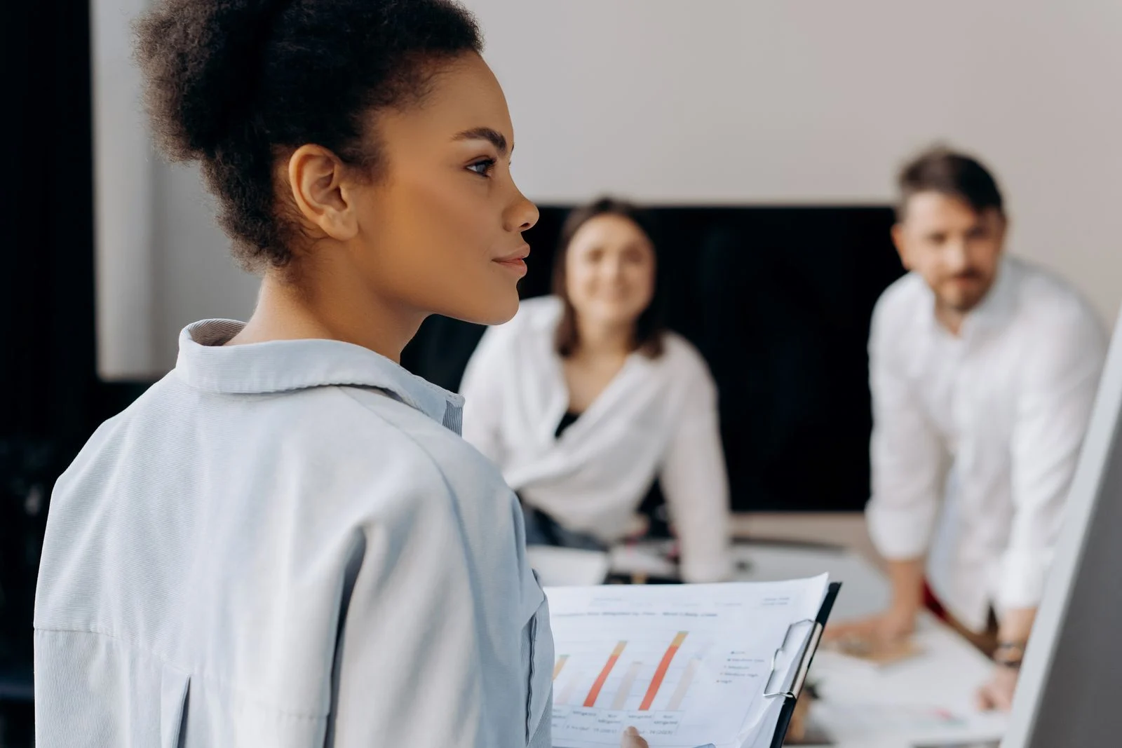 Professionals discussing information during a business meeting.